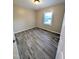 Bedroom featuring wood-look floors and a bright window at 1602 Fairground Rd, Dunn, NC 28334