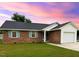 Charming brick home with a well-maintained lawn and attached garage offers curb appeal at 1602 Fairground Rd, Dunn, NC 28334