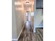 Hallway with wood look floors, neutral paint and white trim throughout at 1602 Fairground Rd, Dunn, NC 28334