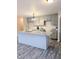 Bright kitchen features gray cabinets, granite counters and a central island with a sink at 1602 Fairground Rd, Dunn, NC 28334