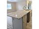 Kitchen island featuring granite counters, sink and ample storage space and stainless faucet at 1602 Fairground Rd, Dunn, NC 28334