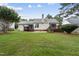Back exterior featuring a fenced yard, deck, and mature trees at 1609 Forest Rd, Wake Forest, NC 27587