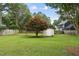Expansive backyard features lush lawn, privacy fence, and mature landscaping at 1609 Forest Rd, Wake Forest, NC 27587