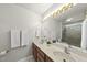 Bathroom featuring double sinks, large mirror with decorative lighting at 1609 Forest Rd, Wake Forest, NC 27587