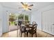 Bright dining room featuring a sliding glass door to the deck and a wooden table set for four at 1609 Forest Rd, Wake Forest, NC 27587
