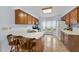 Well-lit kitchen with oak cabinets, stainless steel appliances, a breakfast bar and bay window for natural light at 1609 Forest Rd, Wake Forest, NC 27587