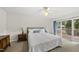 Bright main bedroom featuring sliding glass doors to the deck, neutral décor, and comfortable queen bed at 1609 Forest Rd, Wake Forest, NC 27587