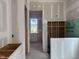 A bathroom features rough drywall, plumbing, and view of an adjacent room at 163 Batten Hill Ln, Selma, NC 27576
