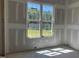 A room with drywall and a window providing natural light and a view of the backyard at 163 Batten Hill Ln, Selma, NC 27576