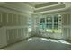 A bedroom with large windows, drywall-covered walls and ceiling, showcasing the natural light at 163 Batten Hill Ln, Selma, NC 27576