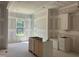 A spacious kitchen with drywall and some cabinets in the process of being installed at 163 Batten Hill Ln, Selma, NC 27576