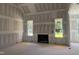 Living room with fireplace framed by two windows and drywall-covered walls and ceilings at 163 Batten Hill Ln, Selma, NC 27576