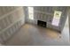 Spacious living room featuring large windows and a fireplace at 163 Batten Hill Ln, Selma, NC 27576