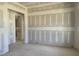 An unfinished living room with newly installed drywall and an open doorway leading to another room at 163 Batten Hill Ln, Selma, NC 27576