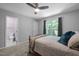 Bedroom features a fan, window view, and connected bathroom at 166 Greenmont Ln, Cary, NC 27511