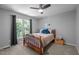 Cozy bedroom featuring natural light, ceiling fan, and neutral carpeting at 166 Greenmont Ln, Cary, NC 27511