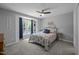 Comfortable bedroom features a large window, fan, and patterned bedding at 166 Greenmont Ln, Cary, NC 27511