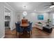 Open-concept dining area boasts wood floors, a modern chandelier and stylish decor at 166 Greenmont Ln, Cary, NC 27511