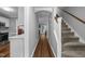 Hallway featuring hardwood floors, gray walls, and leading to a staircase at 166 Greenmont Ln, Cary, NC 27511
