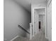 Hallway with a carpeted stairway leading up to bedrooms at 166 Greenmont Ln, Cary, NC 27511