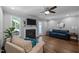 Bright living area features a fireplace, backyard access, and cozy furniture at 166 Greenmont Ln, Cary, NC 27511