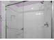 Updated bathroom features white tiled shower with glass door and showerhead at 166 Greenmont Ln, Cary, NC 27511