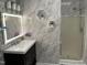 Bright bathroom with a glass enclosed shower, dark vanity, and backlit mirror at 1944 Castle Pines Dr, Raleigh, NC 27604