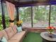 Relaxing sunroom featuring comfortable seating, decorative pillows, and large windows offering a view of lush greenery at 1944 Castle Pines Dr, Raleigh, NC 27604