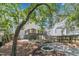 Backyard with deck, stairs, garden, firepit, and tree coverage at 2204 Bellaire Ave, Raleigh, NC 27608