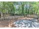 Backyard features a stone patio, fire pit, and fenced yard at 2204 Bellaire Ave, Raleigh, NC 27608
