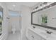 Bright bathroom features double sink vanity, tile flooring, and bathtub shower at 2204 Bellaire Ave, Raleigh, NC 27608