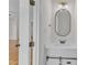 Well-lit bathroom featuring white vanity, modern mirror, and stylish sliding cabinet doors at 2204 Bellaire Ave, Raleigh, NC 27608