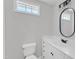 Bathroom features single sink vanity with storage and decorative mirror at 2204 Bellaire Ave, Raleigh, NC 27608