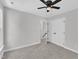 Spacious bedroom featuring ceiling fan, closet, and view to additional room at 2204 Bellaire Ave, Raleigh, NC 27608