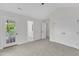 Spacious bedroom with neutral carpet, balcony access, bathroom, and large closet at 2204 Bellaire Ave, Raleigh, NC 27608