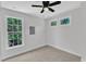 Comfortable bedroom with ceiling fan, carpet, and scenic views from multiple windows at 2204 Bellaire Ave, Raleigh, NC 27608