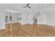 Open dining room featuring hardwood floors, a modern chandelier, and an eat-in bar at 2204 Bellaire Ave, Raleigh, NC 27608