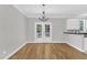 Dining room with hardwood floors, modern chandelier, and French doors leading to the outside at 2204 Bellaire Ave, Raleigh, NC 27608
