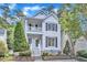 Charming two-story home featuring a double porch, black shutters, and landscaped front yard at 2204 Bellaire Ave, Raleigh, NC 27608