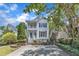 Charming two-story home featuring a double porch, black shutters, and long driveway at 2204 Bellaire Ave, Raleigh, NC 27608