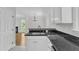 Updated kitchen with granite countertops, stainless sink, and stainless steel dishwasher at 2204 Bellaire Ave, Raleigh, NC 27608