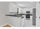 Stylish kitchen featuring white cabinetry, granite countertops, and stainless steel appliances at 2204 Bellaire Ave, Raleigh, NC 27608
