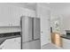 Modern kitchen view featuring stainless steel refrigerator, white cabinets, and granite countertops at 2204 Bellaire Ave, Raleigh, NC 27608