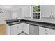 Beautiful kitchen with granite countertops, stainless steel appliances, and sleek white cabinets at 2204 Bellaire Ave, Raleigh, NC 27608