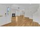 Open-concept living room with hardwood floors, fireplace, and bright natural light at 2204 Bellaire Ave, Raleigh, NC 27608