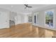 Spacious living room featuring hardwood floors, lots of light, and a staircase leading upstairs at 2204 Bellaire Ave, Raleigh, NC 27608