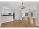Open concept living room showcasing hardwood floors, white trim, and views into the kitchen at 2204 Bellaire Ave, Raleigh, NC 27608