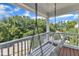 Relaxing porch with swing overlooking landscaped surroundings on a beautiful day at 2204 Bellaire Ave, Raleigh, NC 27608