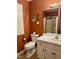 Bathroom featuring a white vanity, tile flooring, and a tiled shower with glass door at 225 Meadow Dr, Henderson, NC 27537