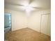 An open bedroom features neutral walls and carpet, complemented by a ceiling fan for optimal comfort at 225 Meadow Dr, Henderson, NC 27537